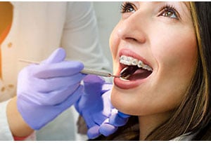 woman getting braces examined